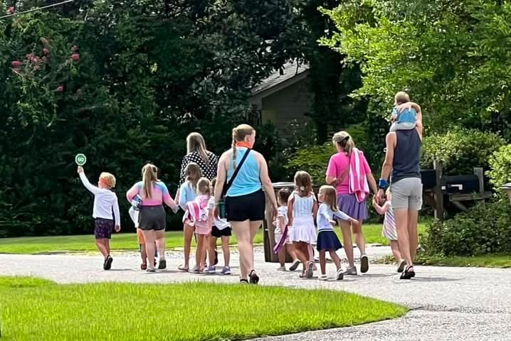 Neighbors and kids walking together down Horloesther Court